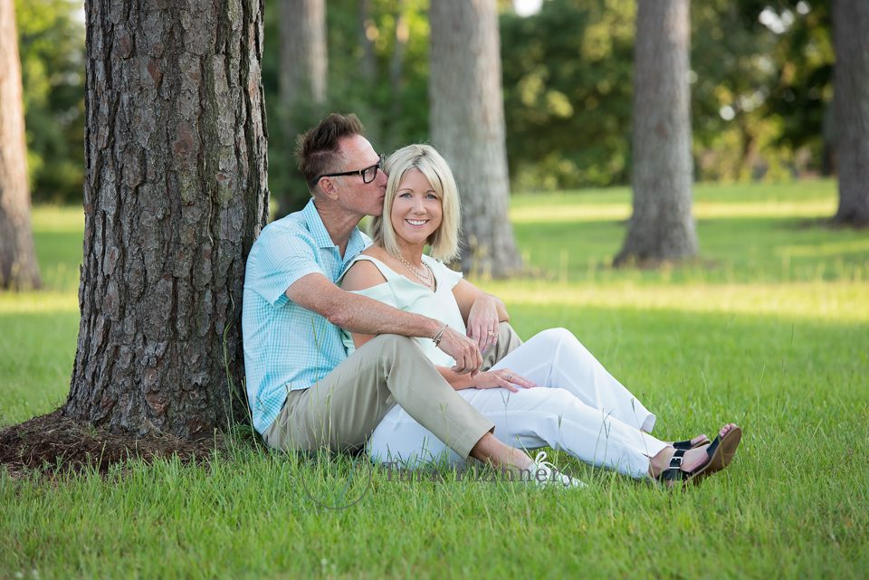 professional family photos with couple sitting on grass outdoors