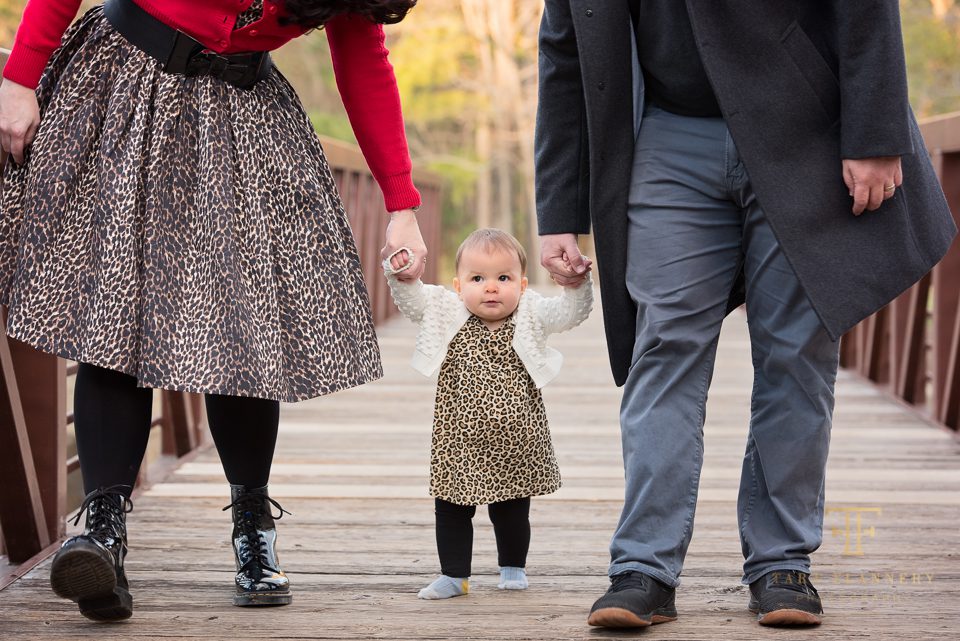 baby walking with parents family photoshoot