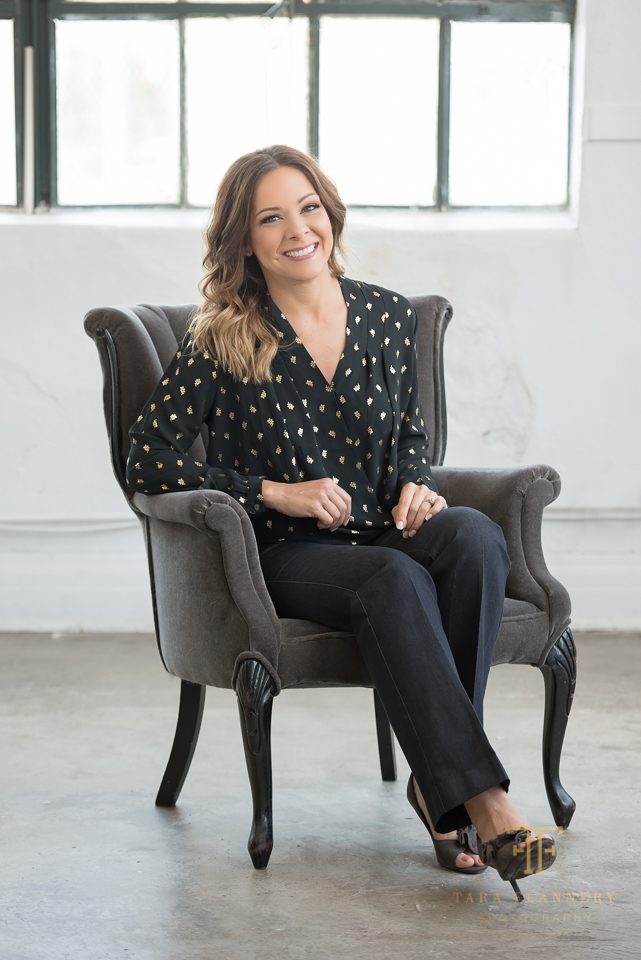 woman posing in chair for headshots