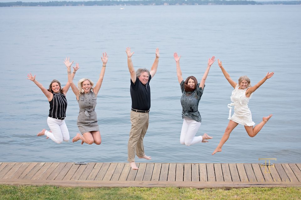 Fun group photo jumping by the lake
