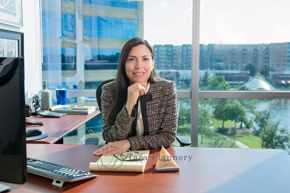 On-location headshot woman in office with outdoor scenery behind