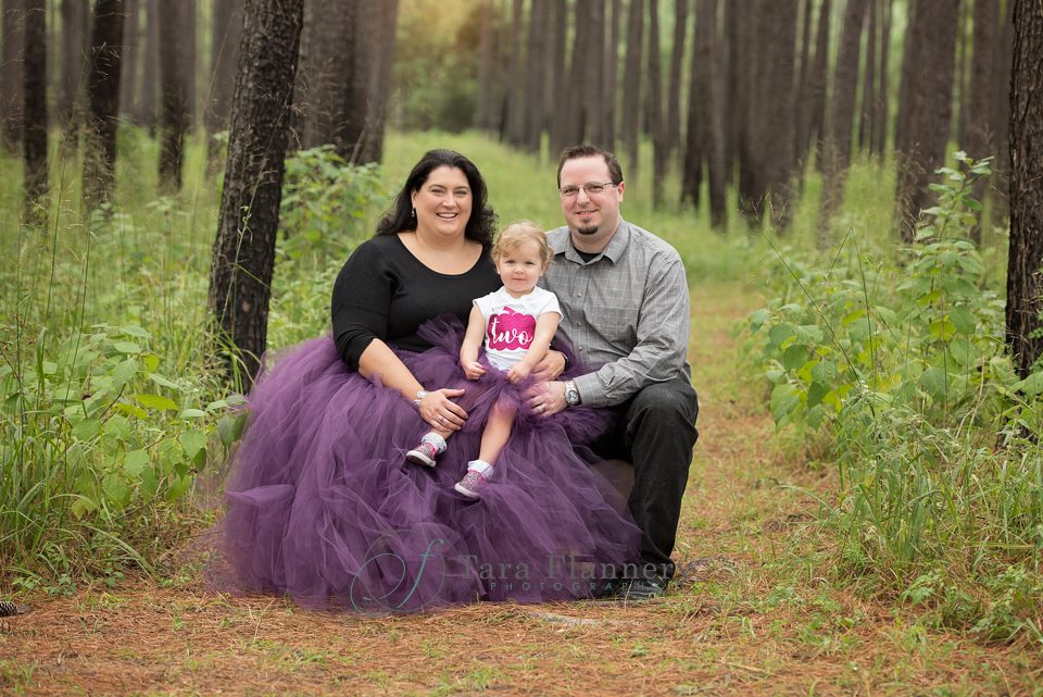 Family portrait in the woods with purple tutus 