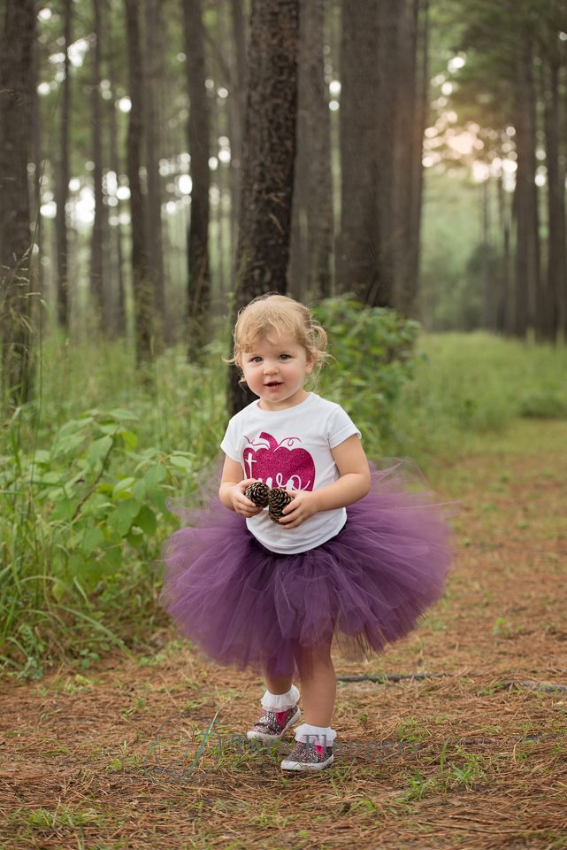 Two year old girl portrait with purple tutu