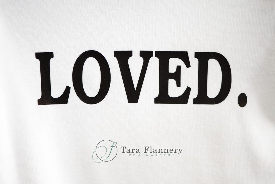 How to Plan an Event baby onesie that says "loved."