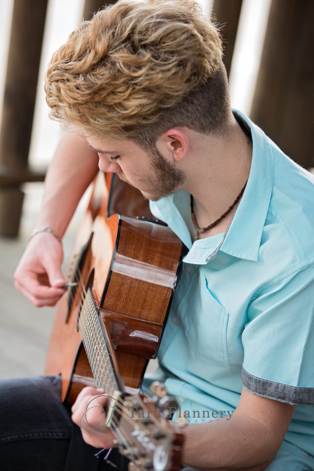 high school senior boy playing guitar 