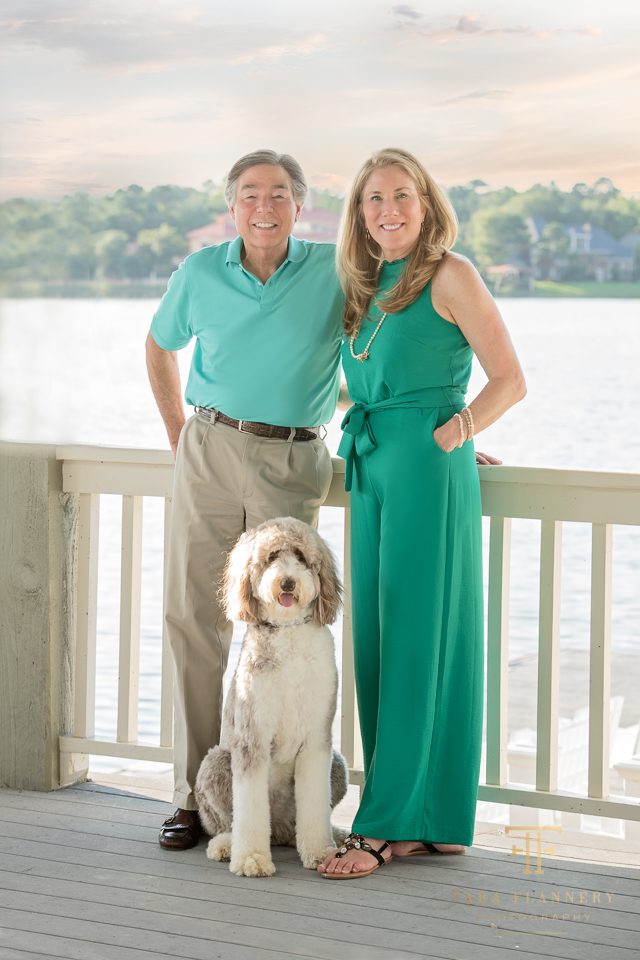 Couple posing with dog for family photos