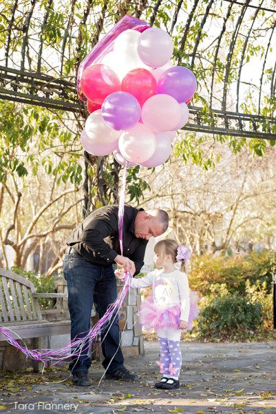Daddy with daughter tying balloons