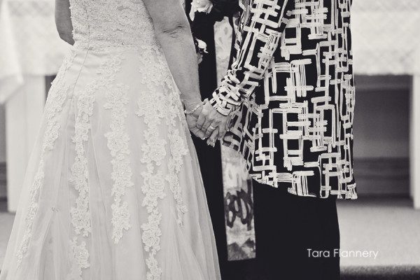 Holding hands during wedding ceremony