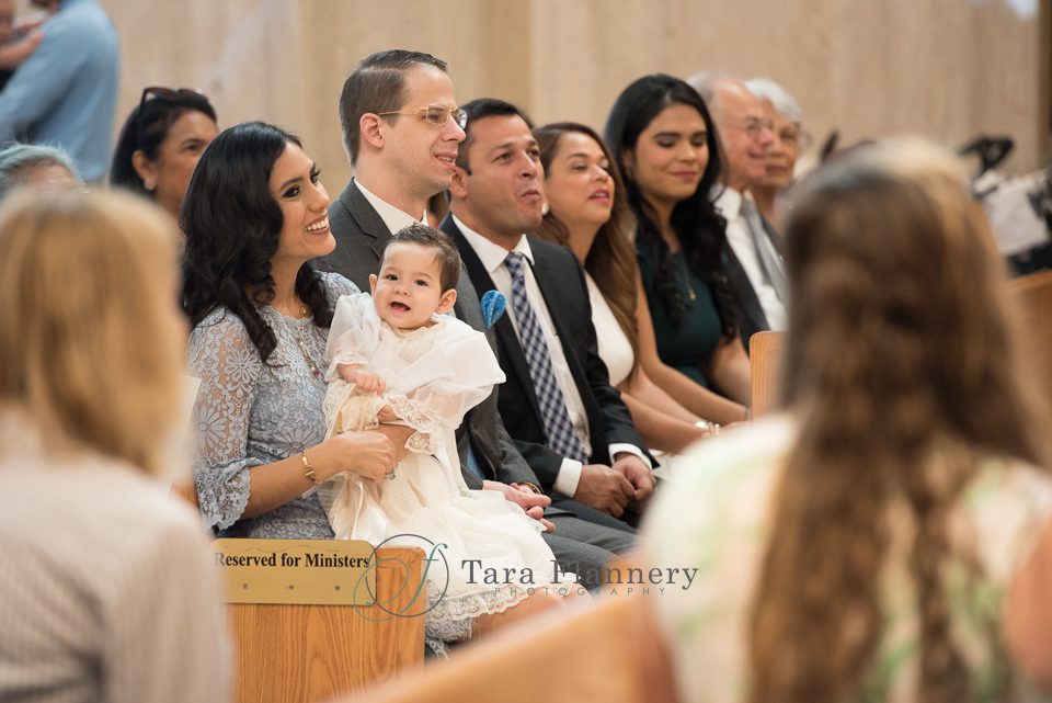 baptism celebration in church surrounded by family