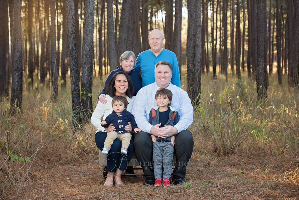 Family portrait with parents, kids, and grandparents in the forest