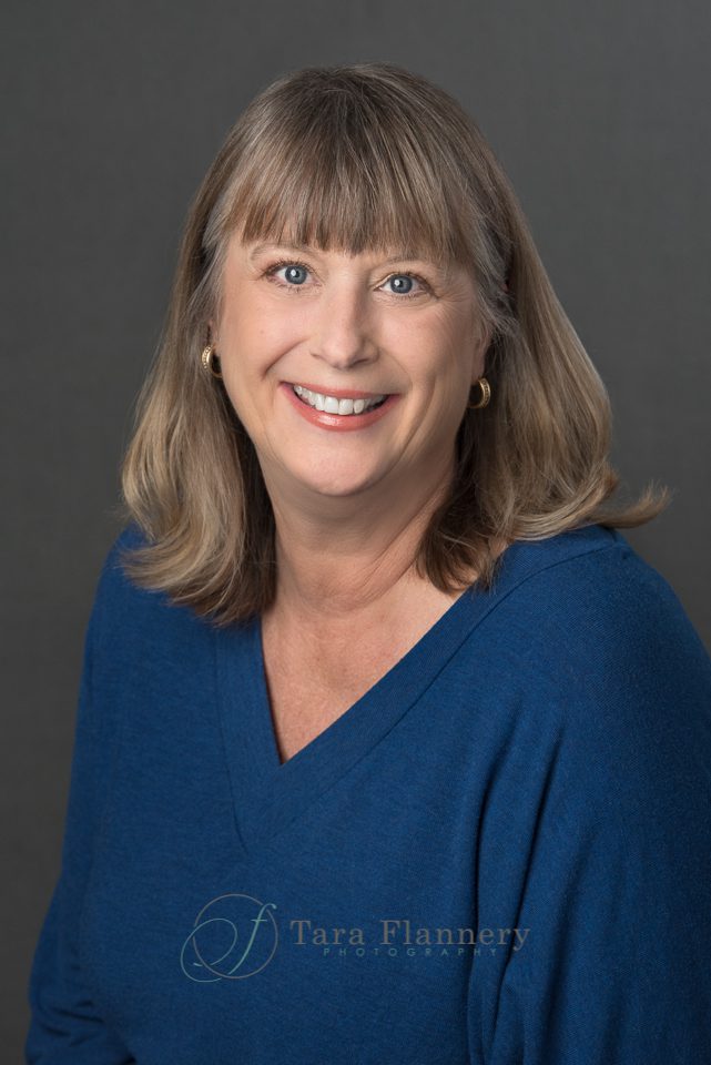 company headshot for woman in blue