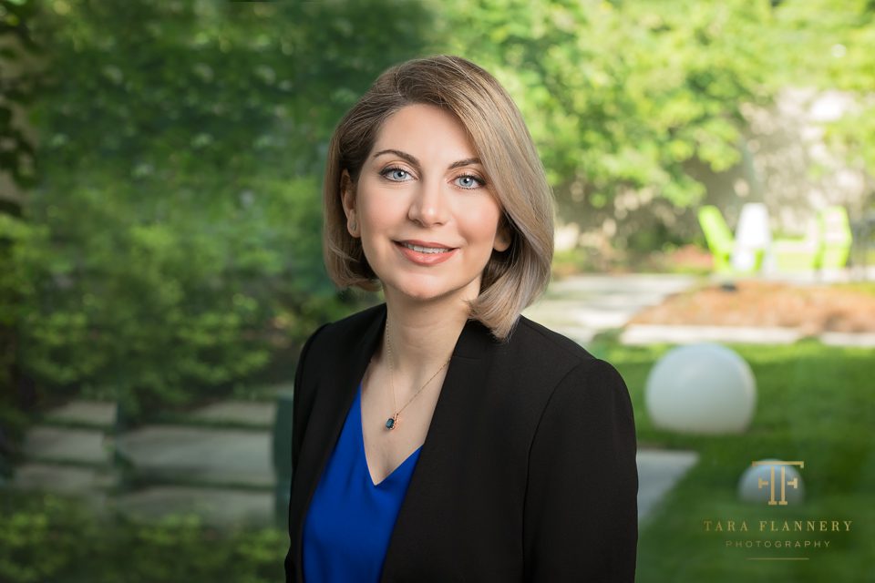 professional woman's headshot with greenery background