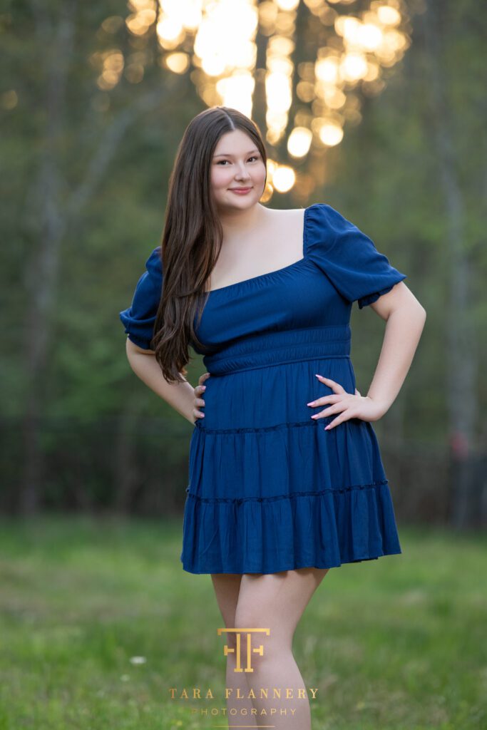 High school senior girl smiles for the camera during her session.