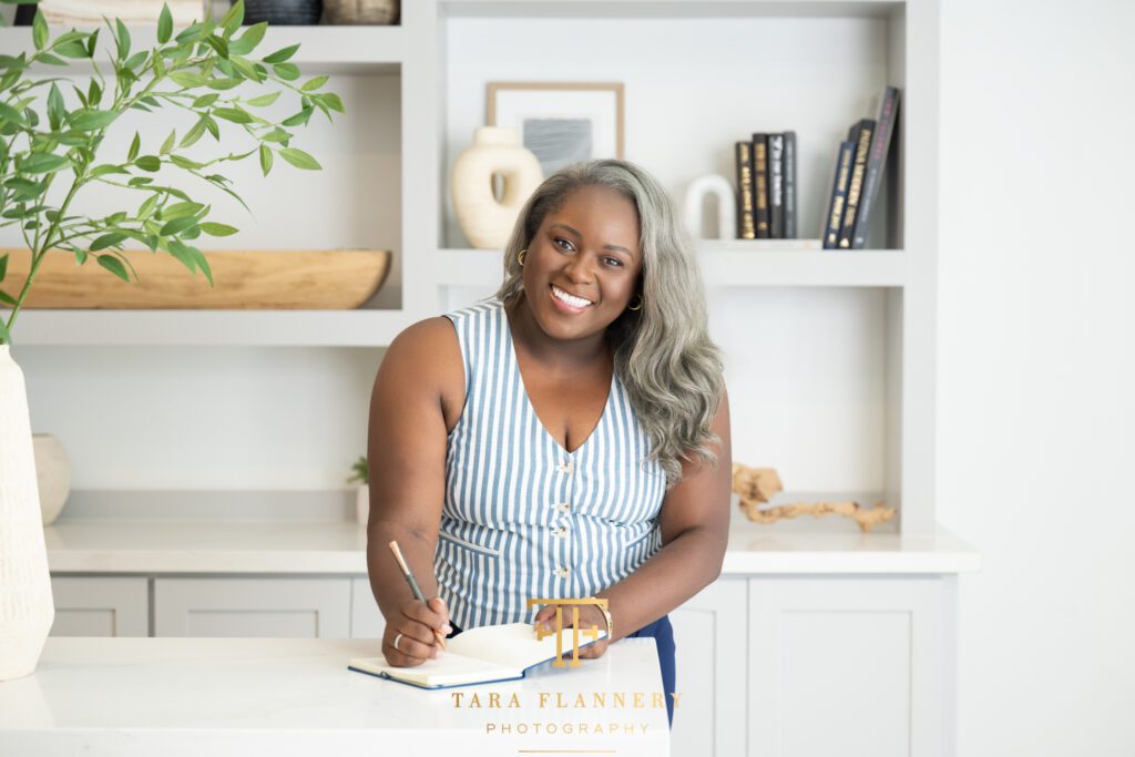 Small business owner takes notes in her office during a branding session.