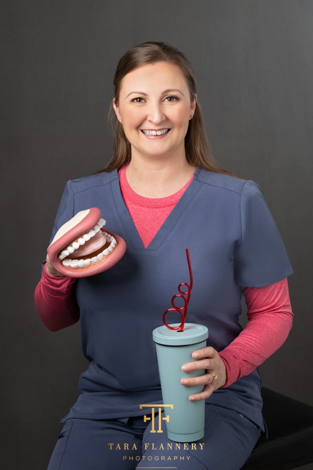 woman in scrubs with props for branding images
