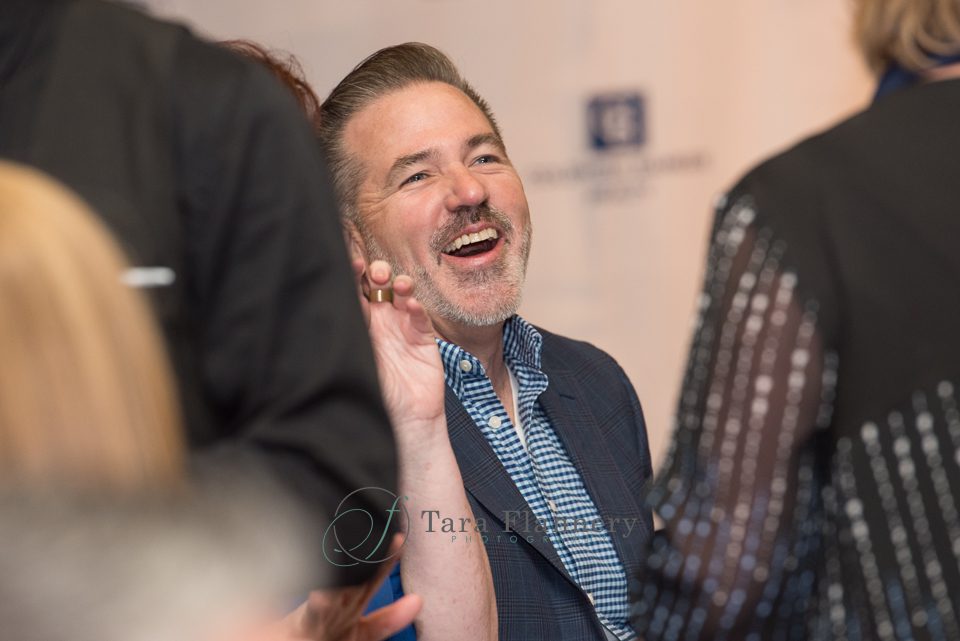 man laughing at corporate event