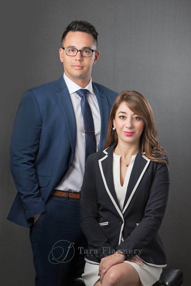 man and woman business partners pose for branding images