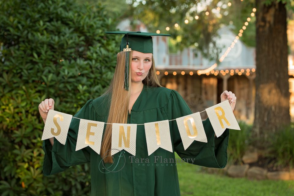 Senior Portraits with senior banner cap and gown