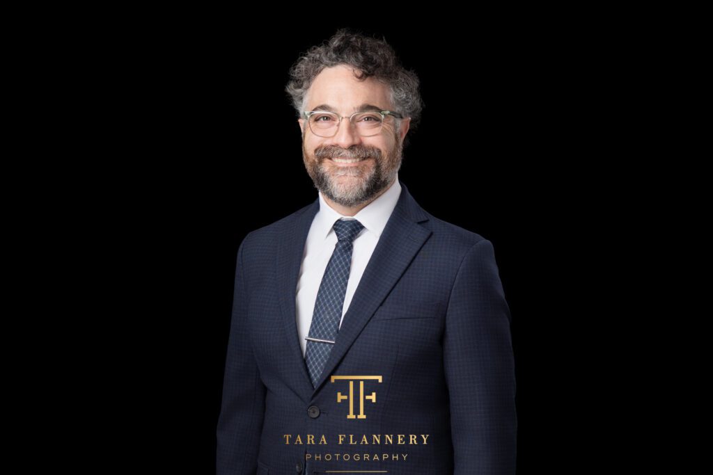 Houston attorney smiles for a company headshots
