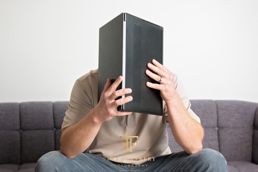 Photo of a man with his head buried in a computer to tell the story of bookkeeping nightmares.