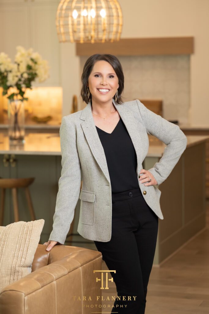Realtor standing in model home poses for a branding photo.