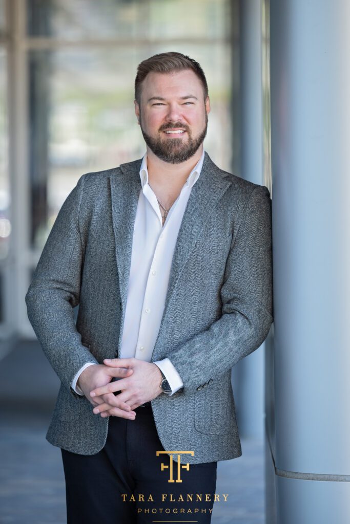 Professional businessman smiling for a branding photo session.