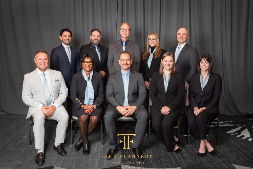 Board of Directors posed for a group photo at a conference.