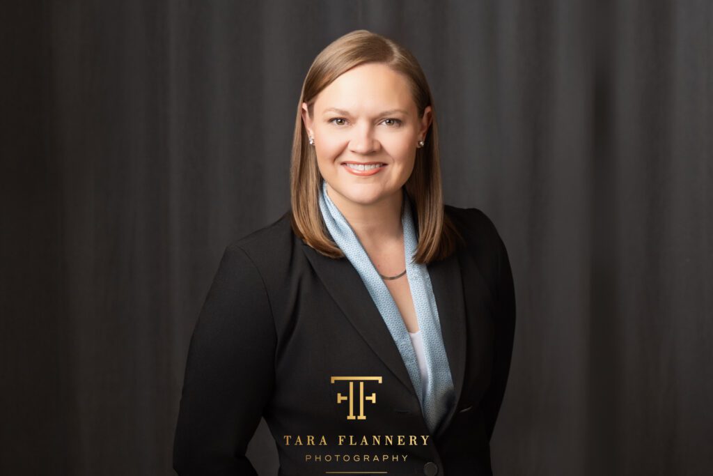 Woman in business attire smiles for a professional headshot.