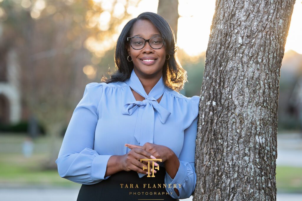 Licensed therapist poses outdoors for a professional headshot in The Woodlands.