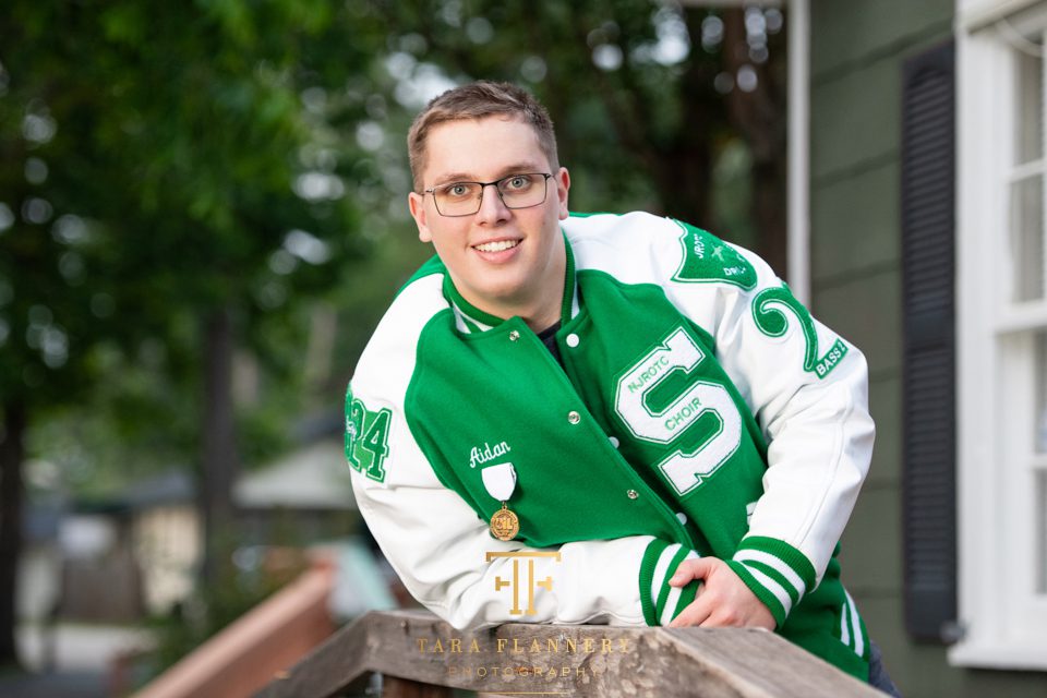 class of 2025 senior photos boy with letter jacket